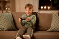 Little boy with gamepad playing video game at home Royalty Free Stock Photo