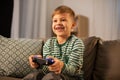 Little boy with gamepad playing video game at home Royalty Free Stock Photo