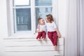 The little boy and girl alone at home watching in the window Royalty Free Stock Photo