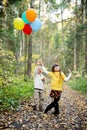 Little boy and girl with balloons in a forest Royalty Free Stock Photo