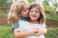 Little boy and girl best friends hugging. Kids kissing each other with love at summer park. Happy kids couple in love Royalty Free Stock Photo