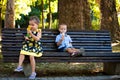 Little boy and girl brother and sister eating ice cream sit on b Royalty Free Stock Photo