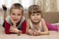 Little boy and girl brother and sister playing together with small turtles animals pets