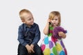 Little boy and girl with cell phone on gray Royalty Free Stock Photo