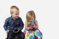 Little boy and girl with cell phones on gray Royalty Free Stock Photo