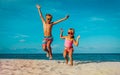 Little boy and girl dance at beach, kids enjoy vacation at sea Royalty Free Stock Photo