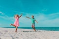 Little boy and girl dance at beach, kids enjoy vacation at sea Royalty Free Stock Photo