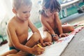 Little boy and girl drawing with crayons Royalty Free Stock Photo