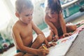 Little boy and girl drawing with crayons Royalty Free Stock Photo