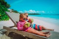 Little boy and girl drinking coconut on beach Royalty Free Stock Photo