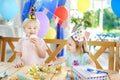 Little boy and girl having fun and celebrate birthday party with cakes Royalty Free Stock Photo