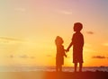 Little boy and girl holding hands at sunset Royalty Free Stock Photo