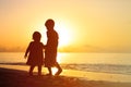 Little boy and girl holding hands walking at sunset Royalty Free Stock Photo