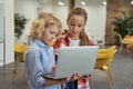 Little boy and girl learning programming, looking at laptop screen while standing in a classroom during STEM lesson Royalty Free Stock Photo