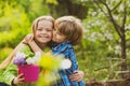 Little boy and girl in love in garden. Cheerful kids playing on park outdoors. Summer portrait of happy cute children Royalty Free Stock Photo