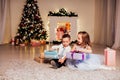 The little boy and girl open Christmas presents Christmas tree new year`s Eve family celebration Royalty Free Stock Photo