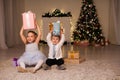 The little boy and girl open Christmas presents Christmas tree new year`s Eve family celebration Royalty Free Stock Photo