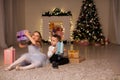 The little boy and girl open Christmas presents Christmas tree new year`s Eve family celebration Royalty Free Stock Photo