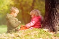 Little boy and girl play with leaves in autumn Royalty Free Stock Photo