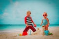 Little boy and girl play with sand building castle on beach Royalty Free Stock Photo