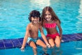 Little boy and girl play in the swimming pool. Children and summer concept Royalty Free Stock Photo