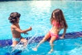 Little boy and girl play in the swimming pool. Children and summer concept Royalty Free Stock Photo
