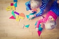 Little boy and girl playing with geometric shapes