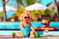 Little boy and girl playing in swimming pool at beach Royalty Free Stock Photo