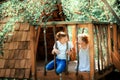 Little boy and girl playing in treehouse at forest park, Active kids on playground, Child enjoying activity in a climbing Royalty Free Stock Photo