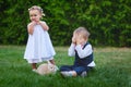 Little boy with the girl and rabbit playing in the grass