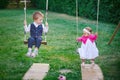 Little boy and girl ride in the park on a swing Royalty Free Stock Photo