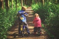 Little boy and girl riding bikes in forest Royalty Free Stock Photo