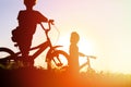 Little boy and girl riding bikes at sunset Royalty Free Stock Photo