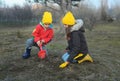 A little boy and girl in rubber boots are walking through the forest and holding shovels. Royalty Free Stock Photo