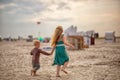 little boy and girl run in the summer along the seashore, holding hands. Brother and sister in natural clothes. Tourism Royalty Free Stock Photo