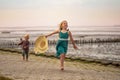 little boy and girl run in the summer along the seashore, holding hands. Brother and sister in natural clothes. Tourism Royalty Free Stock Photo