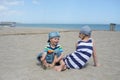 Little boy and girl sitting on the beach Royalty Free Stock Photo