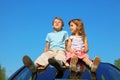 Little boy and girl sitting on car roof Royalty Free Stock Photo