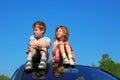 Little boy and girl sitting on car roof Royalty Free Stock Photo