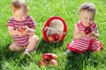 Little boy and girl sitting on the grass in the Royalty Free Stock Photo