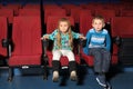 Little boy and girl sitting and watching a movie Royalty Free Stock Photo