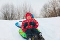 Little boy and girl slide in winter snow Royalty Free Stock Photo