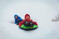 Little boy and girl slide in winter snow Royalty Free Stock Photo