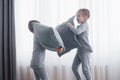 Little boy and girl staged a pillow fight on the bed in the bedroom. Naughty children beat each other pillows. They like Royalty Free Stock Photo