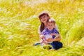 Little boy and girl in the summer field with flowers Royalty Free Stock Photo