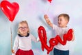 Little boy and girl toddlers with red heart balloons. Valentines day concept Royalty Free Stock Photo