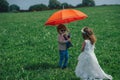 Little boy and girl under red umbrella Royalty Free Stock Photo