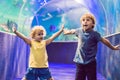 Little Boy and girl watching tropical coral fish in large sea life tank. Kids at the zoo aquarium Royalty Free Stock Photo