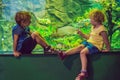 Little Boy and girl watching tropical coral fish in large sea life tank. Kids at the zoo aquarium Royalty Free Stock Photo