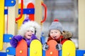 Little boy and girl in winter clothes having fun in outdoors playground Royalty Free Stock Photo